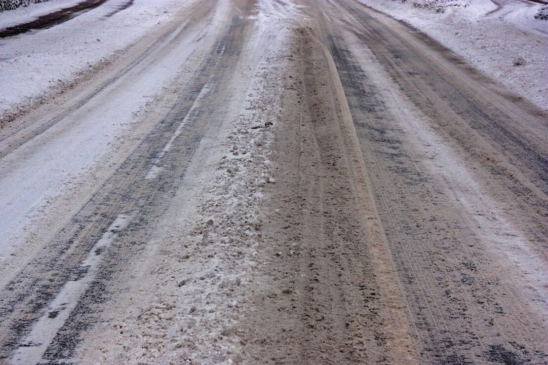slushy road with tire tracks on it, major hazard for vehicles, particularly commercial ones
